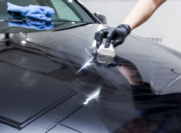 Ceramic coating application for shine done on hood of car with gloves 