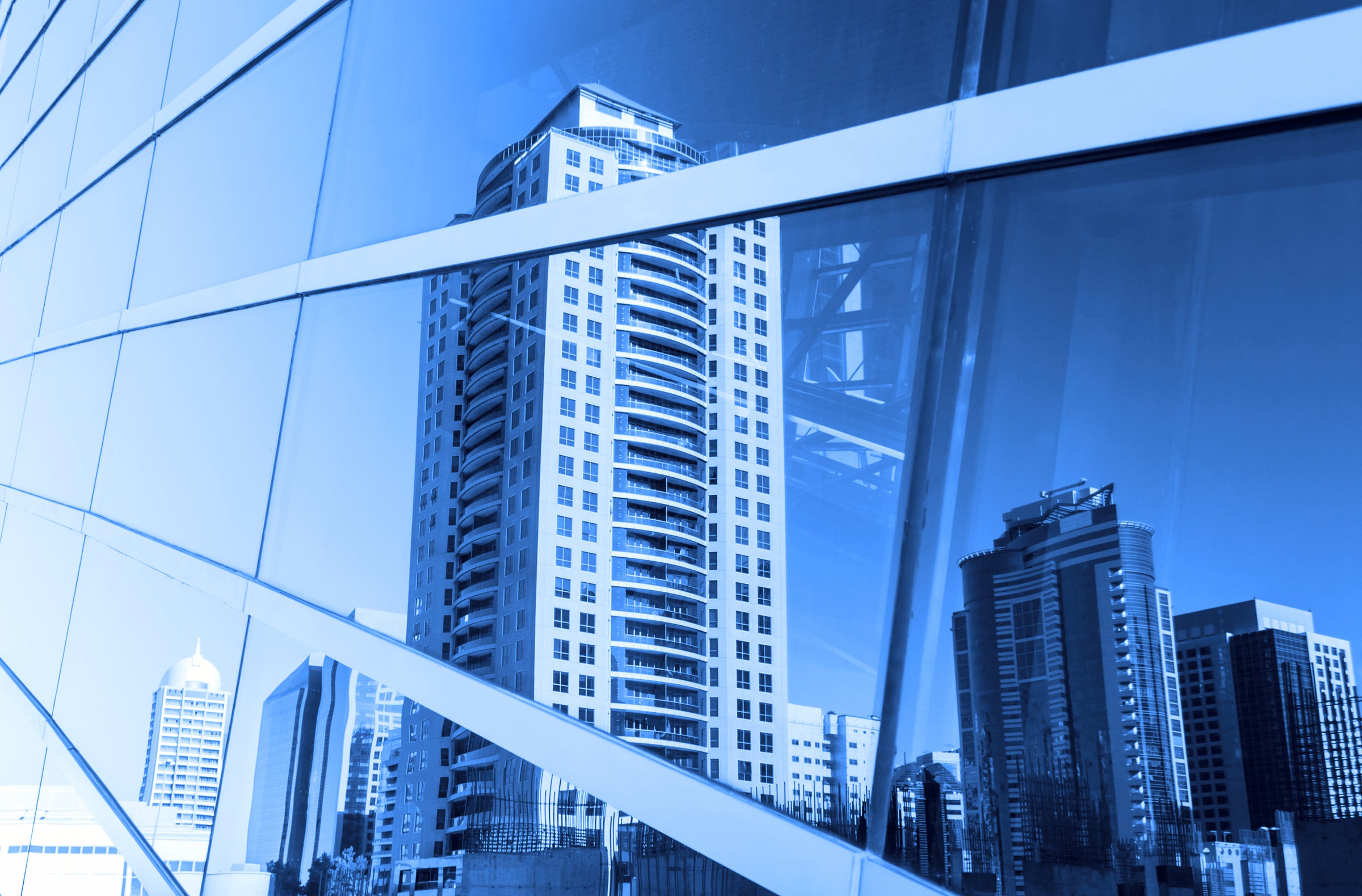 Cityscape reflection in a glass building  with blue window film glare protection for office and employees