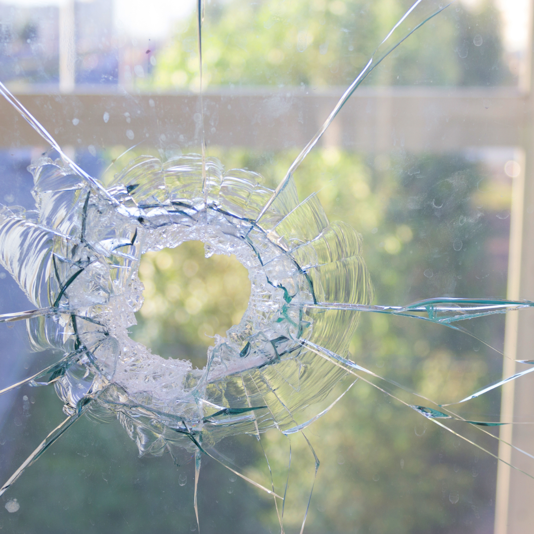 Broken glass stuck together with window film for better protection